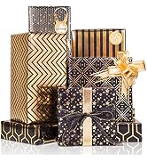 Stack of luxurious gift boxes in black and gold geometric patterns, featuring chevron stripes and art deco designs, tied with gold ribbons and bows.