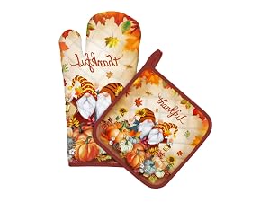 Autumn-themed oven mitt and potholder set with pumpkin and fall foliage design in orange and brown tones.