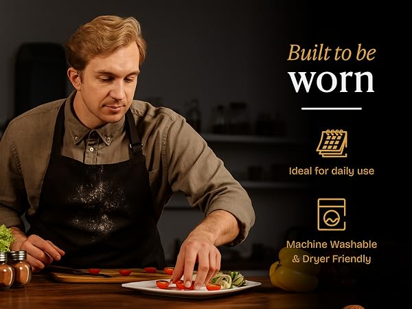 Elegant home chef wearing a black Will Well apron while plating a dish.