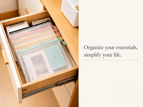 four colorful mesh zipper storage pouches neatly arranged in wooden drawer home storage scene