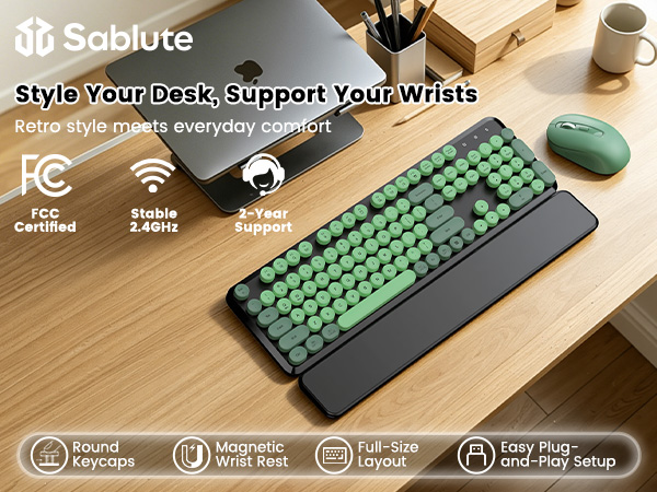 Green Black round-key keyboard and matching mouse with magnetic wrist rest on a wooden desk.