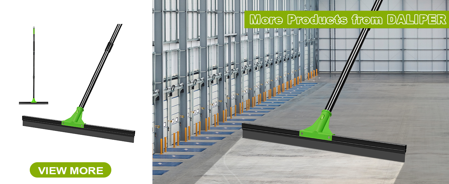 Large floor squeegee with green handle and black rubber blade. Shown in use on industrial concrete floor with metal racking in background.