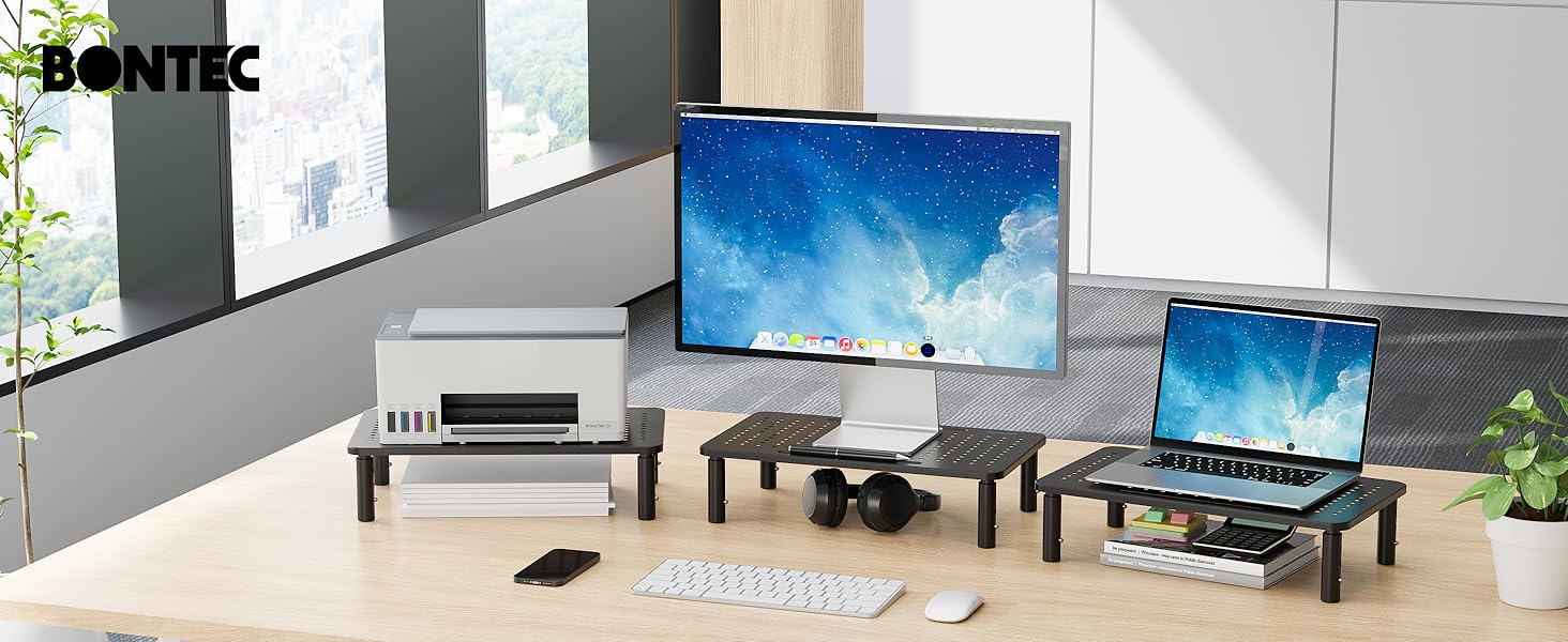 Modern office or workspace setup with multiple monitors and computer displays arranged in a clean, minimalist environment.
