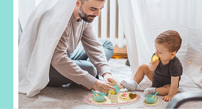 a father and his baby boy playing with their food.