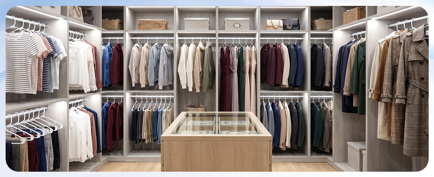 Open closet with white hangers holding shirts, jackets, and pants. Sleek uniform look