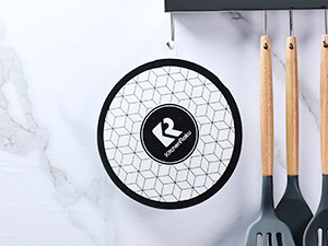 a metal rack with a black and white griddle with a black spatula and a spatula on it.