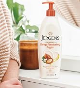Jergens Deep Restoring Argan next to a candle