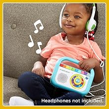 Kid relaxes while listening to music player.