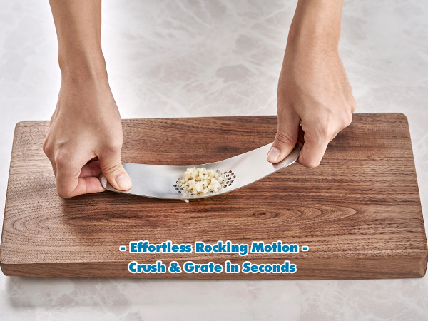 Hands rocking stainless garlic press