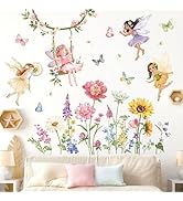 Colorful wall decal set featuring whimsical fairy figures, butterflies, and diverse flowers. Includes sunflowers, daisies, and other wildflowers. Shown applied above a couch with pastel pillows.