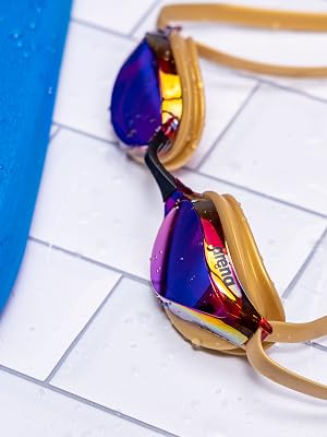 arena unisex adult swim goggles in copper on white tile next to pool for training racing competition