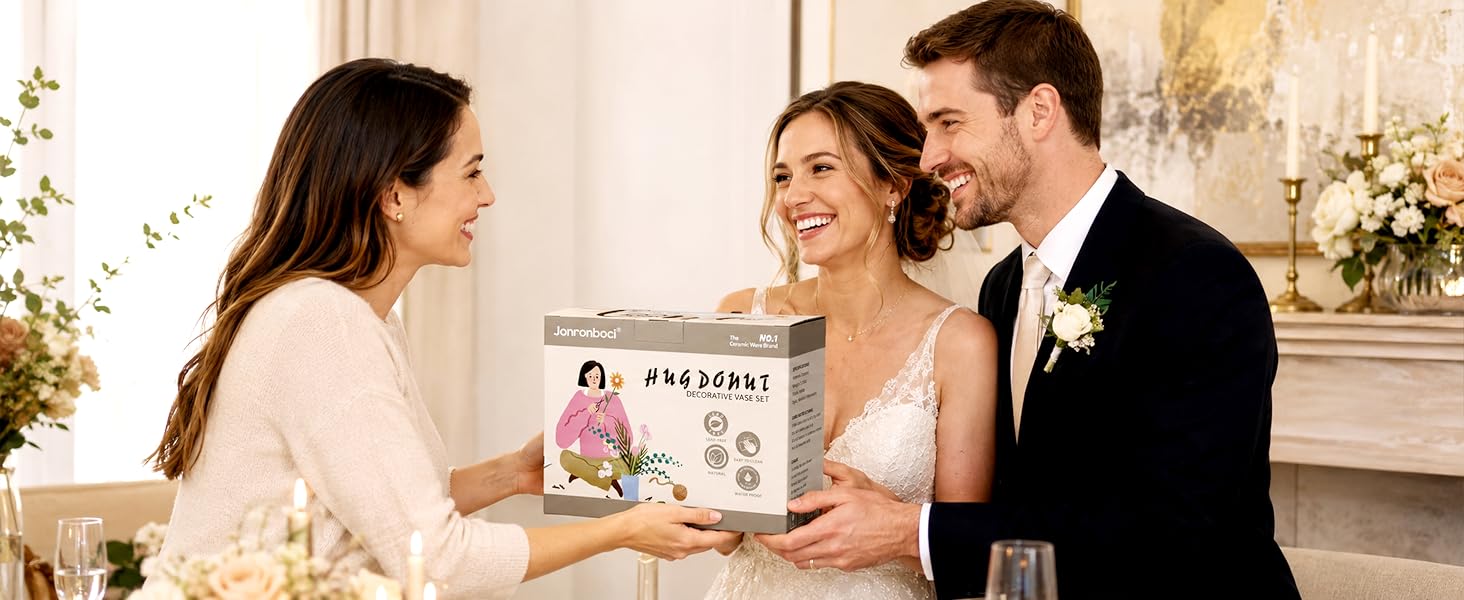 Woman gives vase gift box to bride and groom