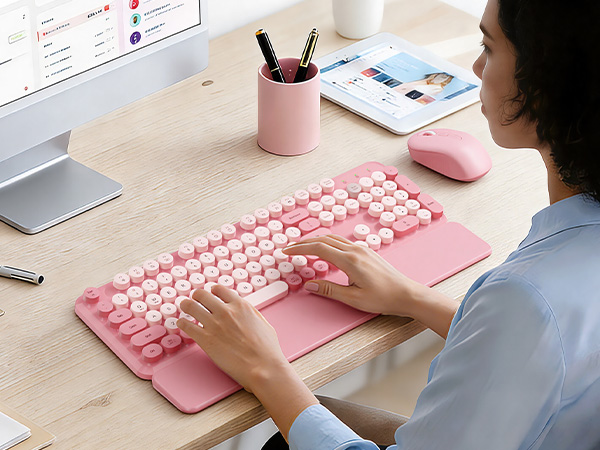 Office worker typing on a lavender retro round-keycap keyboard with wrist rest, with matching mouse