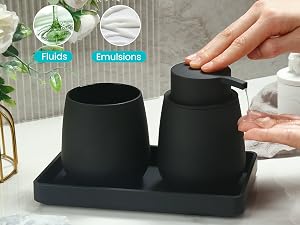 Black bathroom set featuring soap dispenser and tumbler on a tray. Hand demonstrates pump usage. Text indicates 'Fluids' and 'Emulsions' functionality.