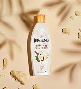Bottle of Jergens Enriching Shea Butter on sand.