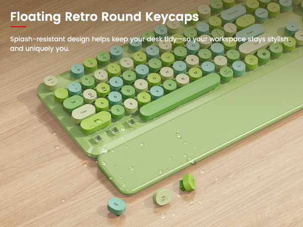 Close-up of green round keycaps and wrist rest with removable keys and splash-resistant design