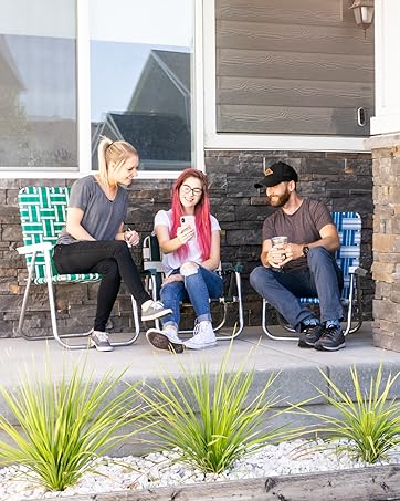 People in lawn chairs looking at a phone