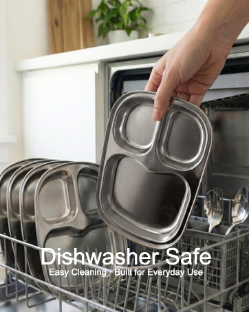Stainless steel divided plate and utensils inside a dishwasher with visible water droplets.