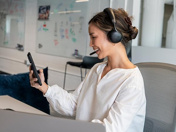 A woman using go work 3 headset with multiple devices