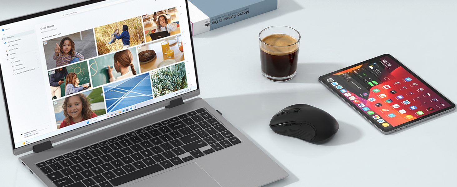 Laptop, smartphone, and computer mouse arranged on desk with coffee cup. Laptop displays photo gallery/collage application interface; smartphone screen shows colorful grid layout. Desktop work setup demonstration.