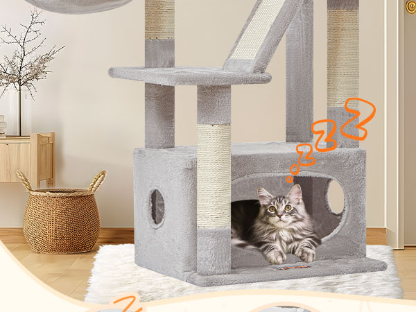 Multi-level cat tree furniture in light gray color with platforms, enclosed cubby areas, and scratching posts. Cat visible resting inside cubby.