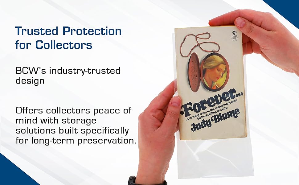Hands inserting a paperback book titled 'Forever' into a BCW protective bag.