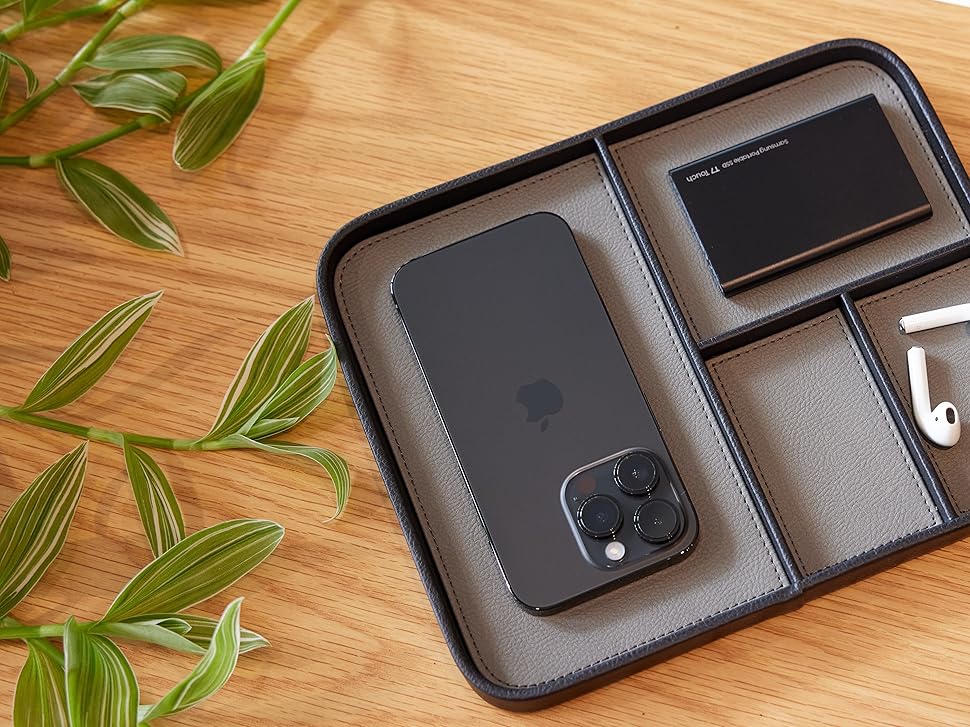 black valet tray top down with iphone, samsung ssd and airpods in the compartments