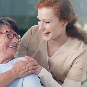 A nurse and elderly patient smiling