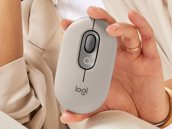 woman posing with pop mouse mist wireless beige gray mouse in her hand