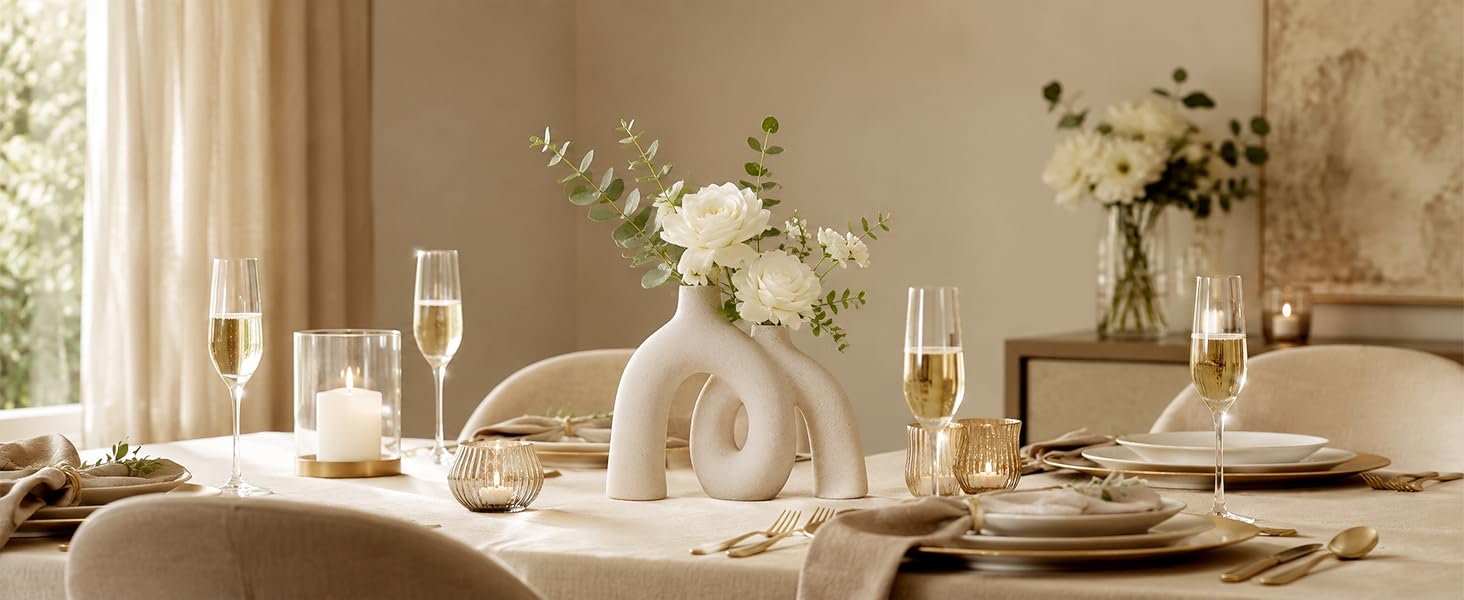 Cream ceramic donut vase with white flowers on a romantic anniversary table.