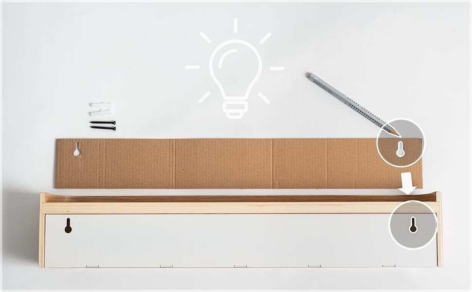 Minimalist wooden shelf or organizer with illustrated instruction icons showing light bulb and droplet symbols against white wall.