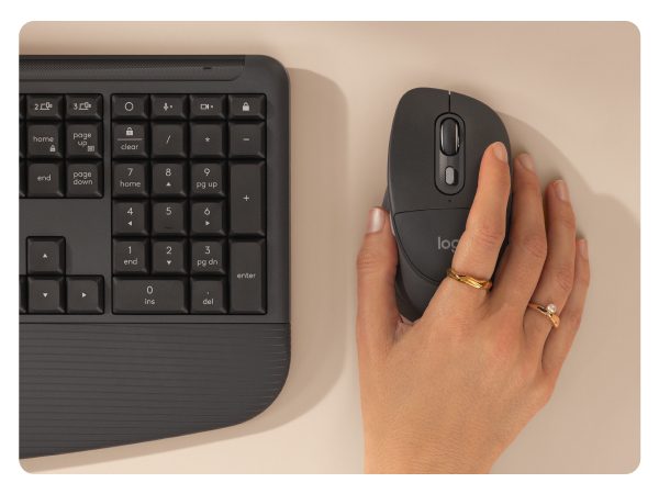 a hand holding a graphite mouse