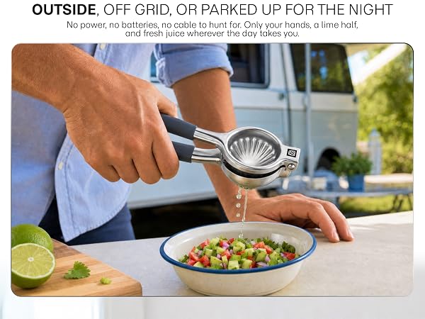 Outside a camper van, a man squeezes a lime over salsa with a press that needs no electricity.