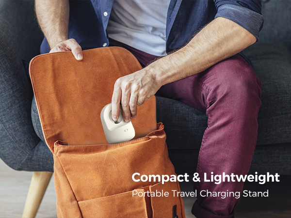 Person inserting a small white device into an orange bag or pouch. Text describes it as a compact and lightweight portable travel charging stand.