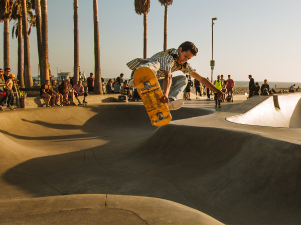 Man at the skate park doing a trick