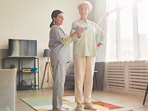 a woman and a woman are standing in a living room.