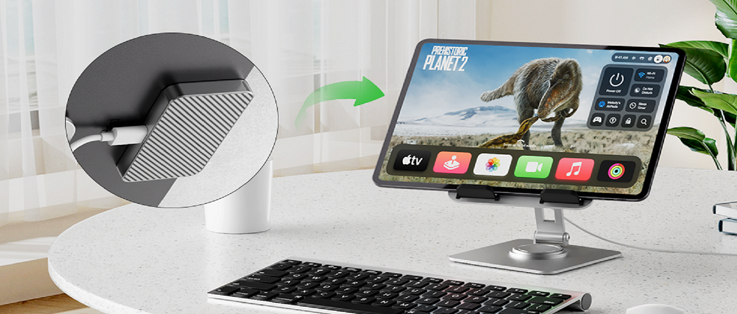 Modern white desk setup featuring a curved device holder or dock with smartphone and keyboard visible in the workspace.