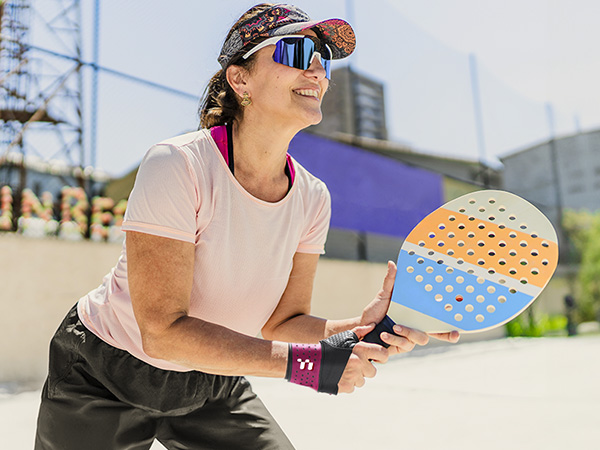 a woman holding a tennis racket in her hands.