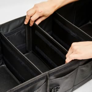 A hand places a long divider inside the NINEDUCK trunk organizer.