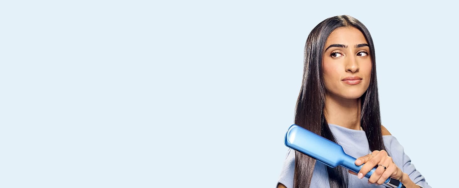 Woman straightening hair