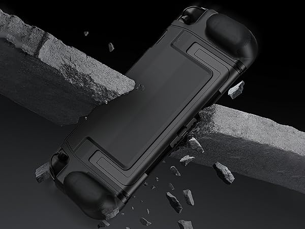Black protective case for handheld gaming device, featuring a rugged design with raised edges and textured grips. Shown on a broken concrete surface suggesting durability.