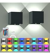 Two black cube wall lights casting up-down beams. Remote control and USB cable shown. Grid of 16 colored light patterns demonstrating various illumination options.