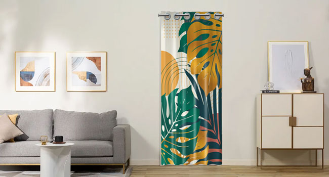 Tropical-themed room divider screen with green and yellow leaf pattern. Placed in living room with gray sofa and framed artwork.