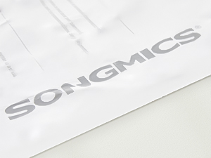 Close-up of a white surface with embossed text 'SONGMICS' visible.