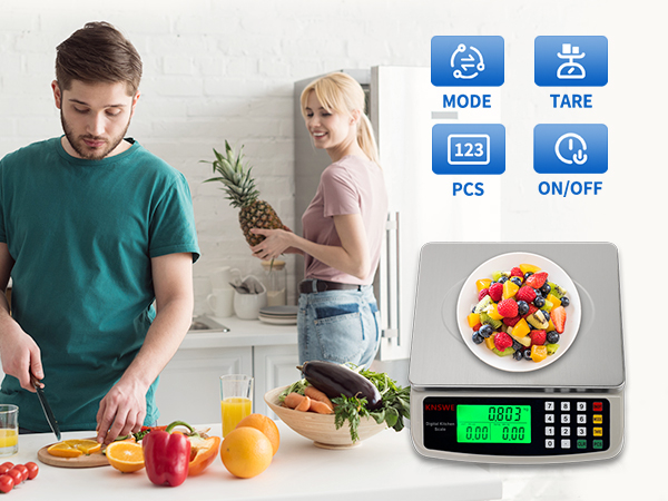 a man and a woman in the kitchen with a scale and fruit on the counter.