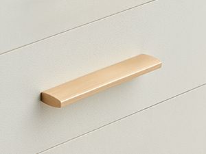 Simple wooden door or drawer handle mounted on a white surface, likely showcasing minimalist hardware design.