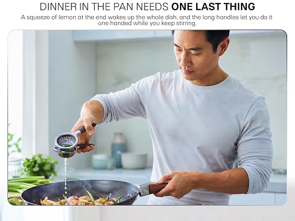 A cook squeezes fresh lemon into a hot wok one handed while he keeps stirring the pan.