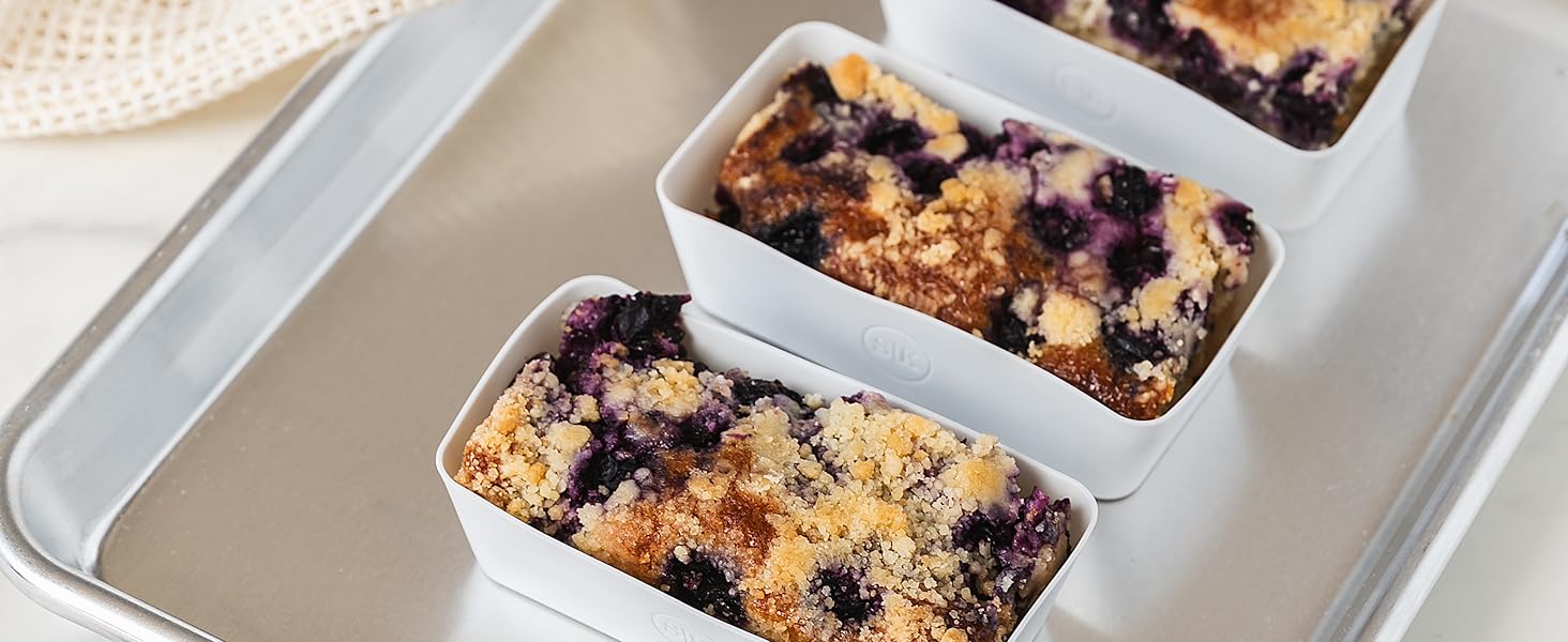 Rectangle silicone baking cup with a blueberry crumble on a baking sheet