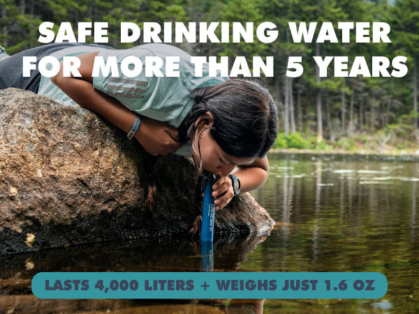 Person drinking from stream from LifeStraw