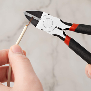 a hand holding a pair of pliers